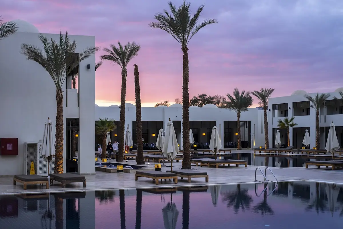 Poolside terrace of a boutique hotel at dusk